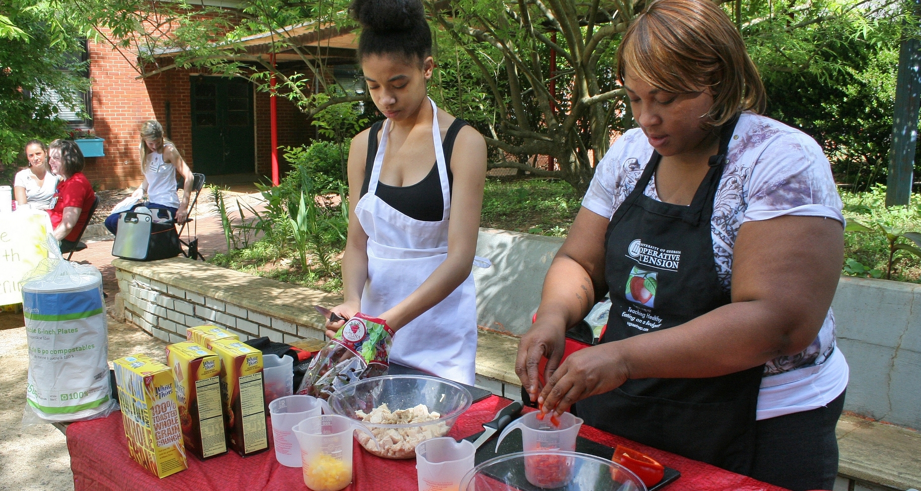 Extension volunteers prepare food at a demonstration
