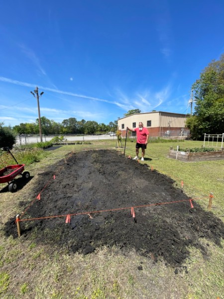 Jay W. next to freshly prepared row crop bed