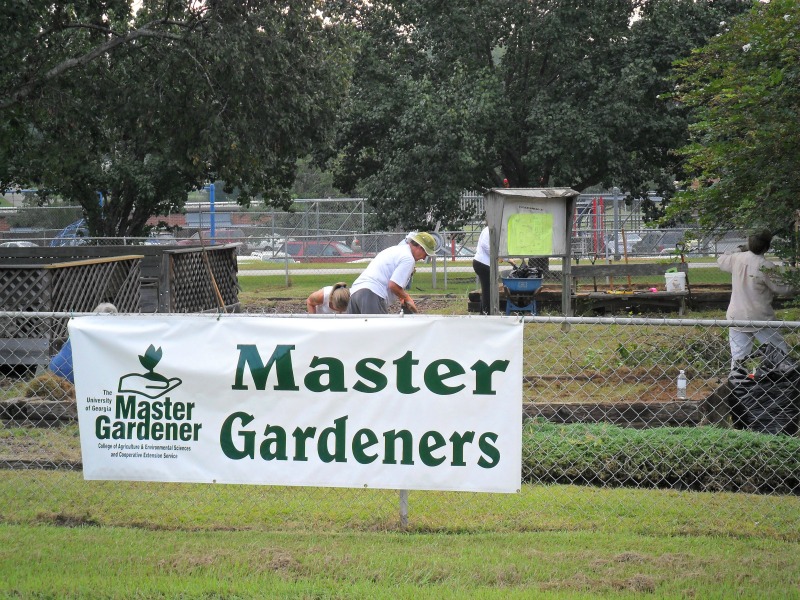 Master Gardener sign hung on a fence at a cleanup event