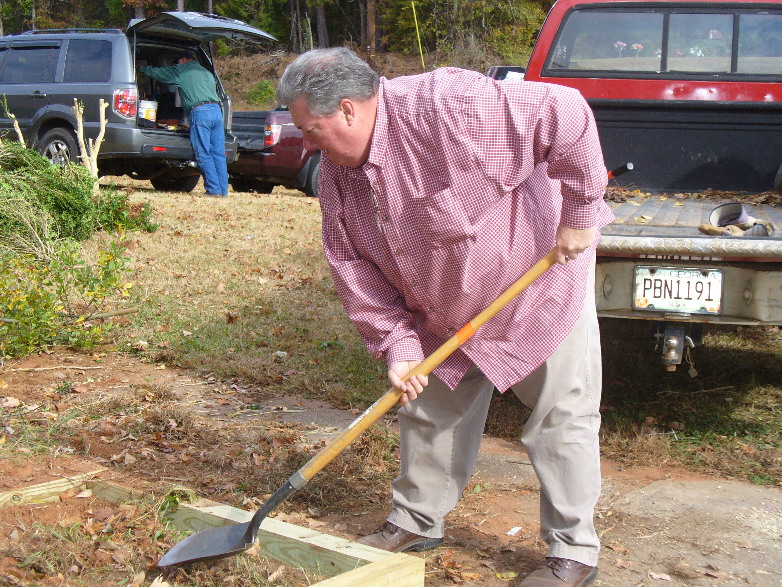 Master Gardener volunteer digging out a raised bed