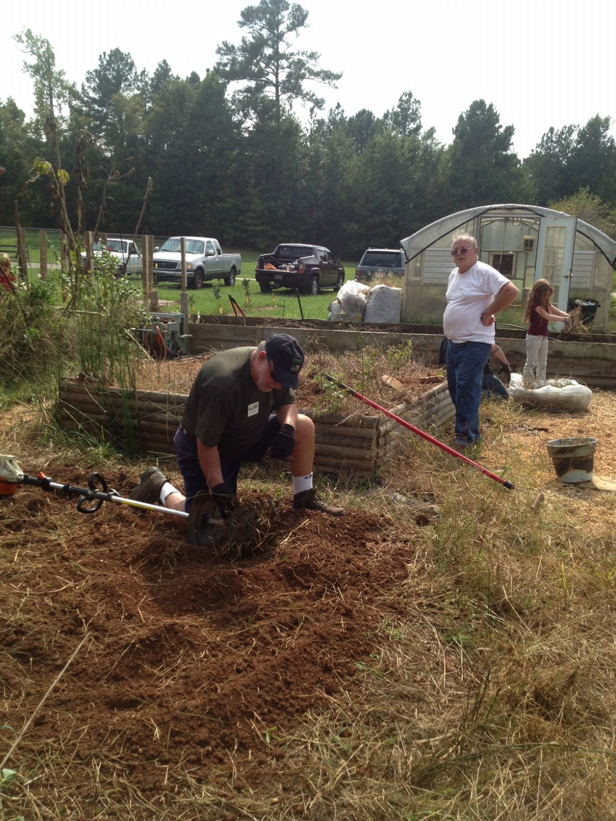 Master Gardener Extension Volunteer tilling soil